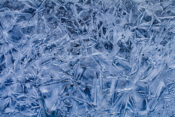 Photo of frozen ice in blue tones. Winter natural background for design. - Photo, Image