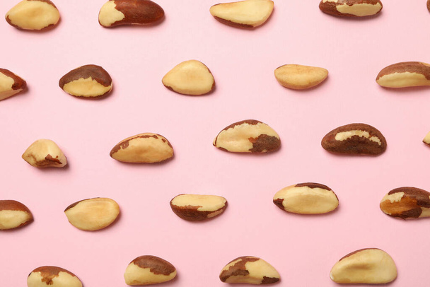 Flat lay with tasty brazil nuts on pink background - Zdjęcie, obraz