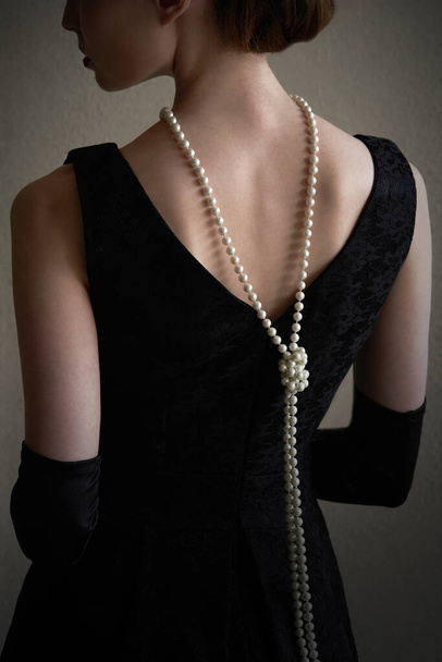 Historic fashion woman in a beautiful dress and beads - Фото, зображення