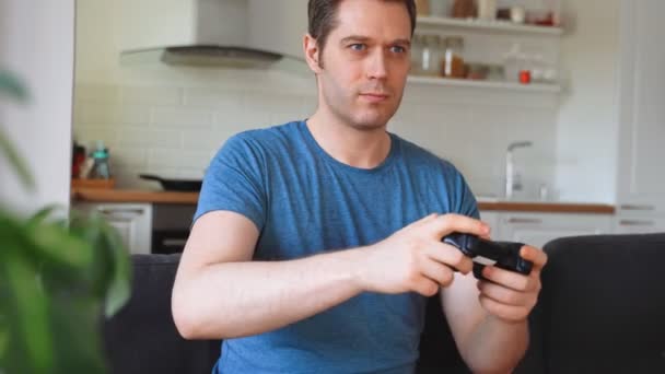 Handsome man with joystick playing game. - Footage, Video