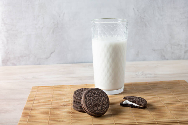 Cookies with a glass of milk on a wooden table - Foto, afbeelding