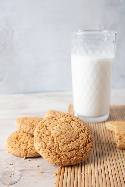 Cookies with a glass of milk on a wooden table - Photo, image