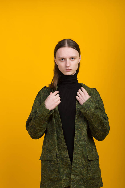 Androgen. Androgynous character on yellow background. Man or woman. Military style. - Valokuva, kuva