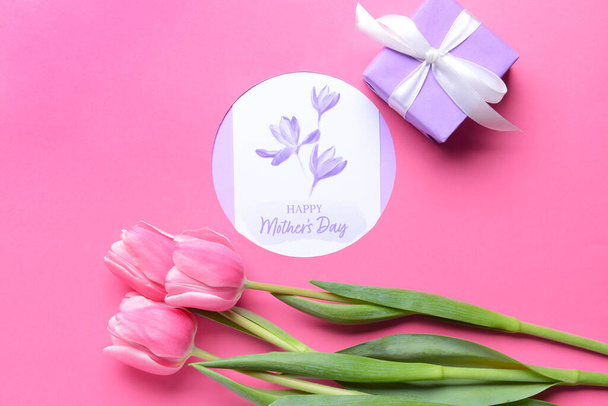 Composición con hermosas flores y tarjeta de felicitación para el Día de la Madre sobre fondo de color - Foto, imagen