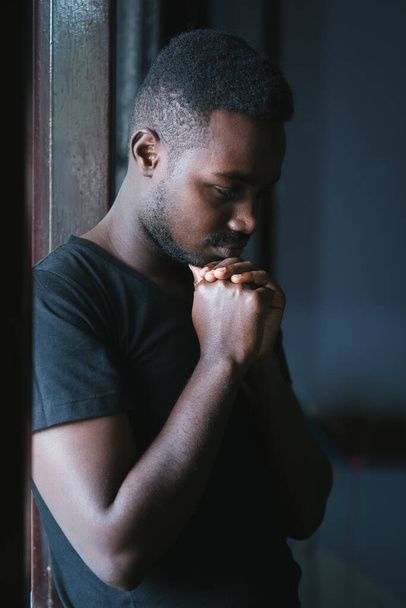 Sad african man in dark room , Low key style - Photo, Image