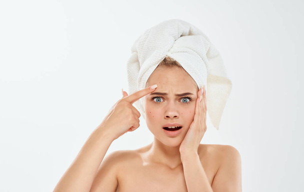 Frustrated woman gesturing with hands and a towel on her head bare shoulders - Foto, Imagen