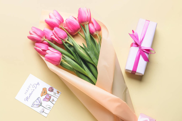 Bellissimi fiori, regalo e biglietto di auguri per la festa della mamma sullo sfondo a colori - Foto, immagini