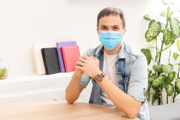 quarantine due coronavirus pandemic. stay at home. business man working from home, wear a protective mask. Work from home with disinfectant gel. remote work, learning due to the epidemic COVID-19 - Φωτογραφία, εικόνα