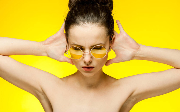 brunette with bare shoulders yellow glasses emotions isolated background - Foto, Imagem