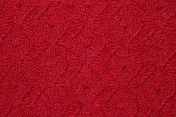 knitted texture of patterns on bright red knitwear, a fragment of women's clothing - Photo, Image