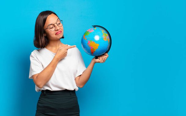 young pretty woman with a world globe map - 写真・画像
