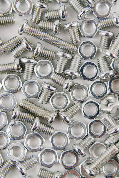 a iron screws and nuts on a white background for repair close up - Foto, Imagem