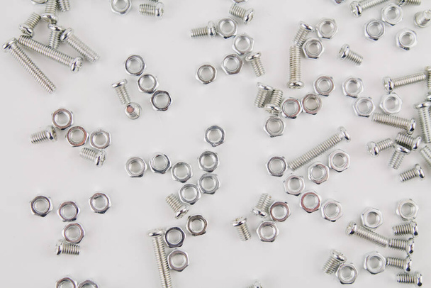 a iron screws and nuts on a white background for repair and construction - Valokuva, kuva