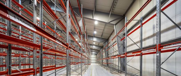 Modern interior of new empty warehouse. Racks pallets shelves. Metal construction. Storage equipment. - Photo, Image