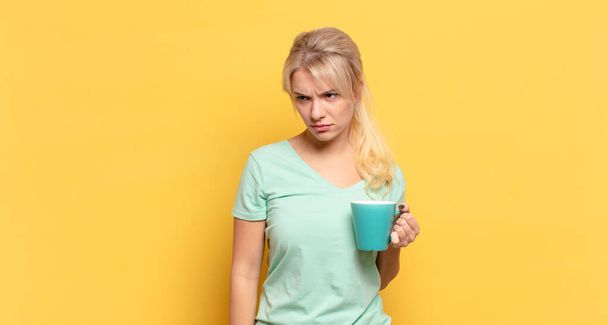 blonde woman feeling sad, upset or angry and looking to the side with a negative attitude, frowning in disagreement - Foto, Bild