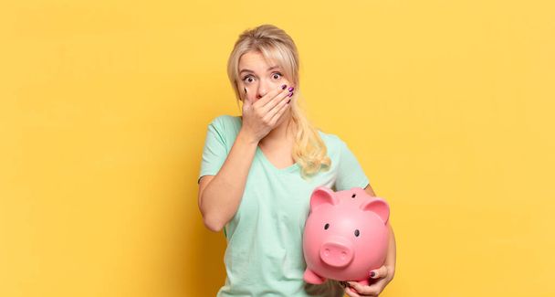 blonde woman covering mouth with hands with a shocked, surprised expression, keeping a secret or saying oops - Photo, Image