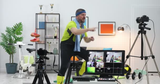 Funny-looking fitness instructor shooting exercise videos for vlog at home. Sport coach or athlete influencer record live streaming - Footage, Video