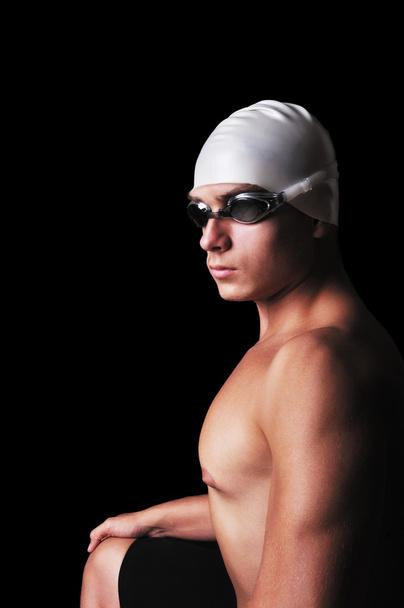 Muscular male swimmer isolated on black - Фото, изображение