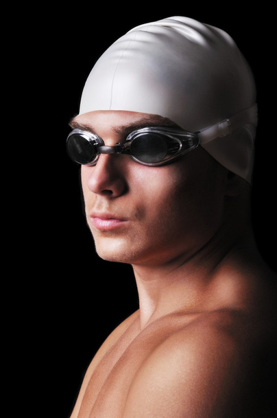 Muscular male swimmer isolated on black - Fotoğraf, Görsel