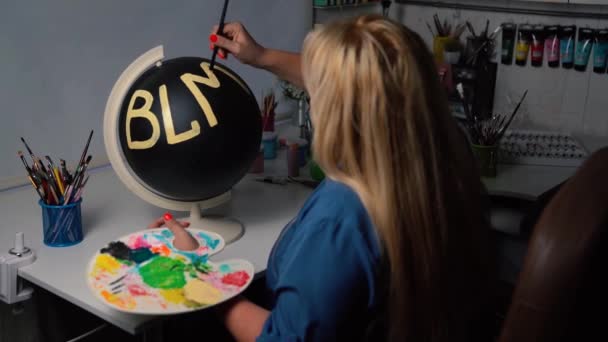 Übergewichtige Frau malt BLM-Zeichen auf die schwarze Erdkugel - Filmmaterial, Video