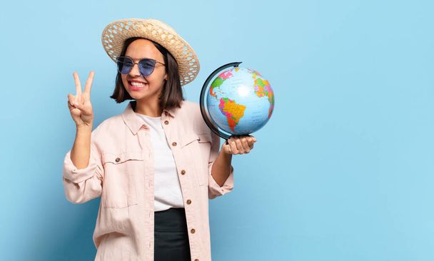 young pretty traveler woman with a world globe map. travel or holidays concept - Фото, зображення