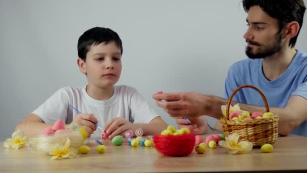 Happy easter. Cute boy is painting Easter eggs. Happy little boy getting ready f - Footage, Video