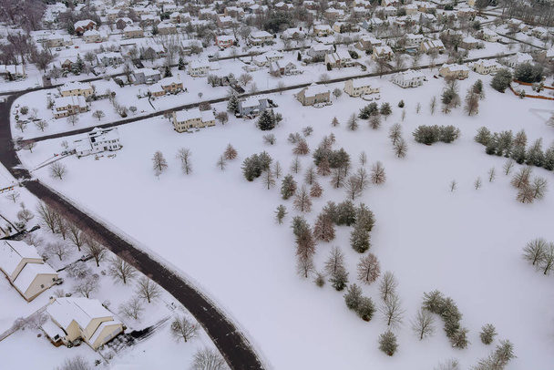 Aerial view of snowed in traditional housing estate in the suburbs in dangerous weather conditions - Photo, Image