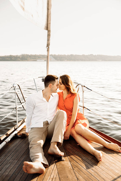 Happy couple on a yacht in the summer of celebrating honeymoon. High quality photo - Photo, Image