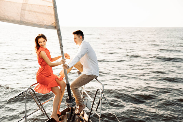 Couple in love on a yacht in the blue sea. High quality photo - Photo, Image