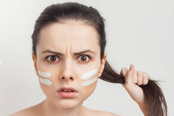 emotional brunette cream face mask bare shoulders cropped view clear skin - Photo, Image