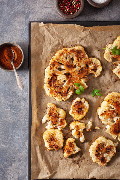 cauliflower steaks with herb and spice on baking tray. plant based meat substitute - Photo, Image