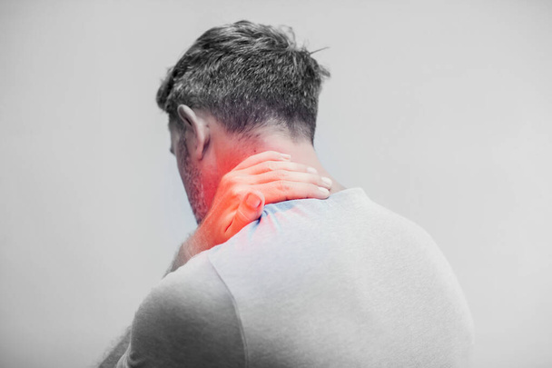 Pessoas, cuidados de saúde e conceito de problema - close-up do homem que sofre de dor no pescoço sobre fundo cinza - Foto, Imagem