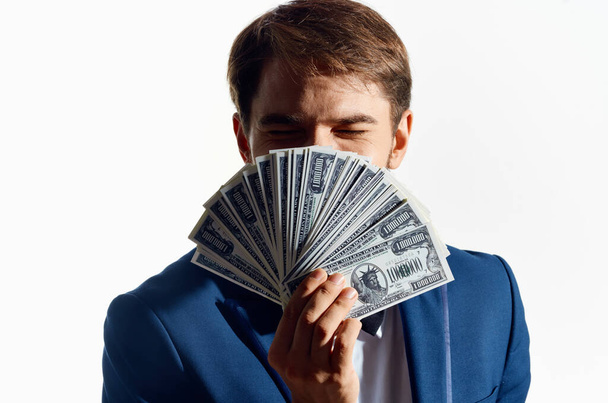 rich man with a bundle of money in his hand and a classic suit on a white background - Foto, Imagen