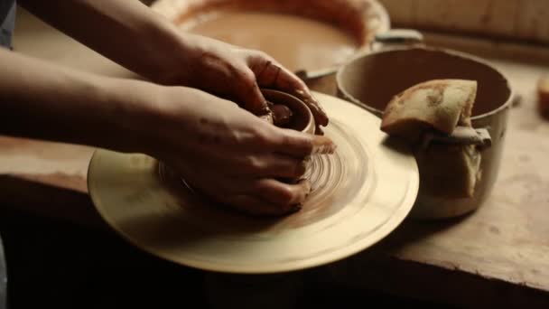 Unknown girl working with potters wheel in studio. Woman modeling clay product - Footage, Video