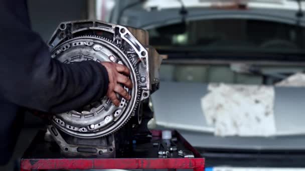 Automatikus Autószerelő Telepített lendkerék a javítóműhelyben Autó motor felvétel. - Felvétel, videó