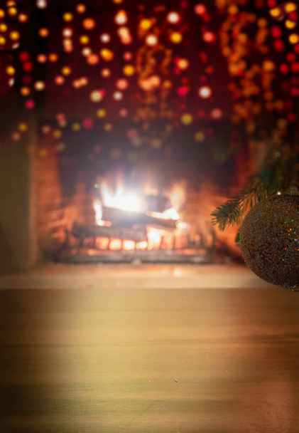 Xmas interior home celebration concept. Vertical close up view of Christmas tree branch with silver golden sparkle ball and bokeh blur burning fireplace background, copy space. Warm family moments. - Photo, Image