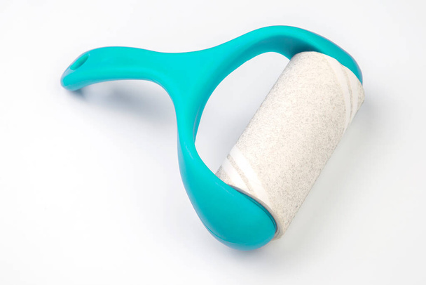 sticky plastic roller for cleaning clothes from dust, lint and hai - Photo, Image