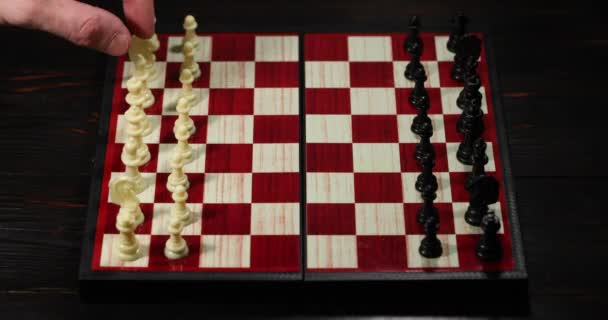 Peón blanco pasos en frente. Piezas de ajedrez en un tablero de ajedrez. El juego comenzó. Concepto empresarial. - Metraje, vídeo
