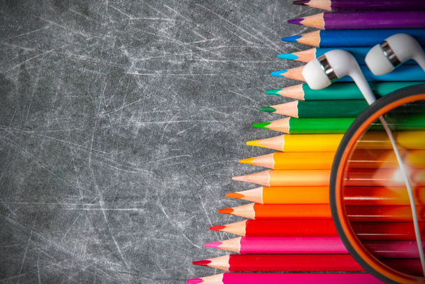 multicolored school supplies lie on black chalkboard, short focus, partial blur - Photo, Image