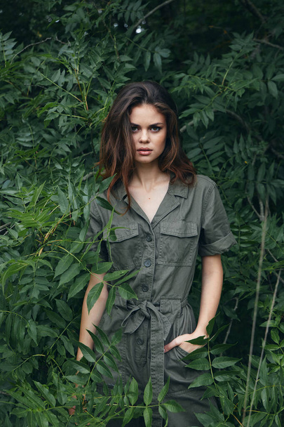 Woman outdoors green jumpsuit is sexy.nature travel - Photo, image