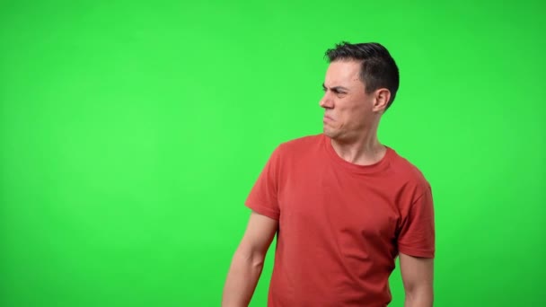 Man looking aside suspicious. Chroma green background. - Footage, Video