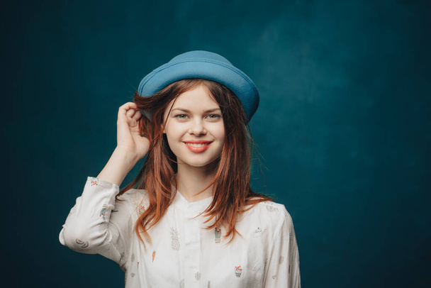 emotional woman in blue hat gesturing with hands red hair blonde sweater - Foto, immagini