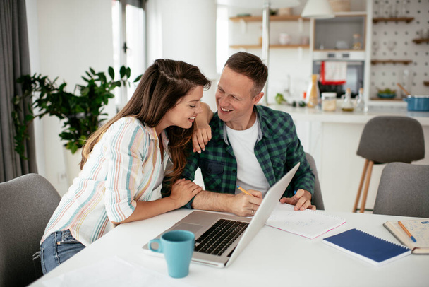 Boldog fiatal pár használja laptop otthon - Fotó, kép