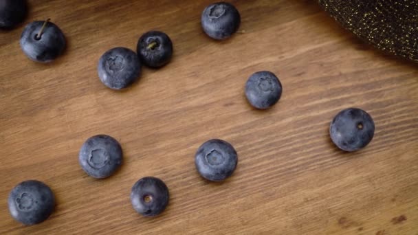 Several blueberries on a wooden table close-up. - Footage, Video