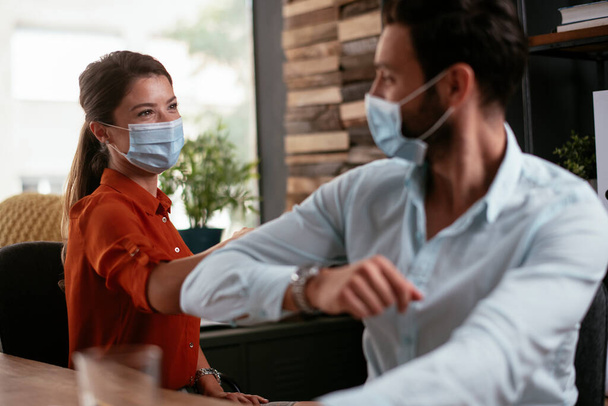 Businessman and businesswoman with medical mask in office. Colleagues working in office. - Foto, Imagem