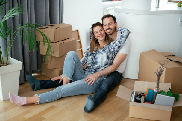 Boyfriend and girlfriend are moving in a apartment. Young couple are unpacking their belongings. - 写真・画像
