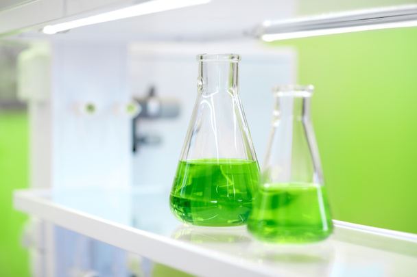 palloni con liquido verde sullo sfondo del lavoro chimico
 - Foto, immagini