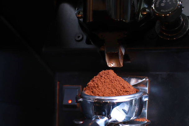 Close-up, coffee holder, ground coffee beans are poured into the filter and funnel background is blurred - Photo, Image