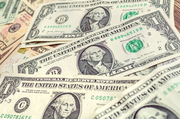 Money, US dollar banknotes background. One dollar banknotes in close-up. Photography for Finance and Economy concept. - Foto, immagini