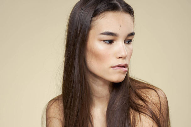 Pretty woman naked shoulders cosmetics clean skin hair care beige background - Фото, зображення
